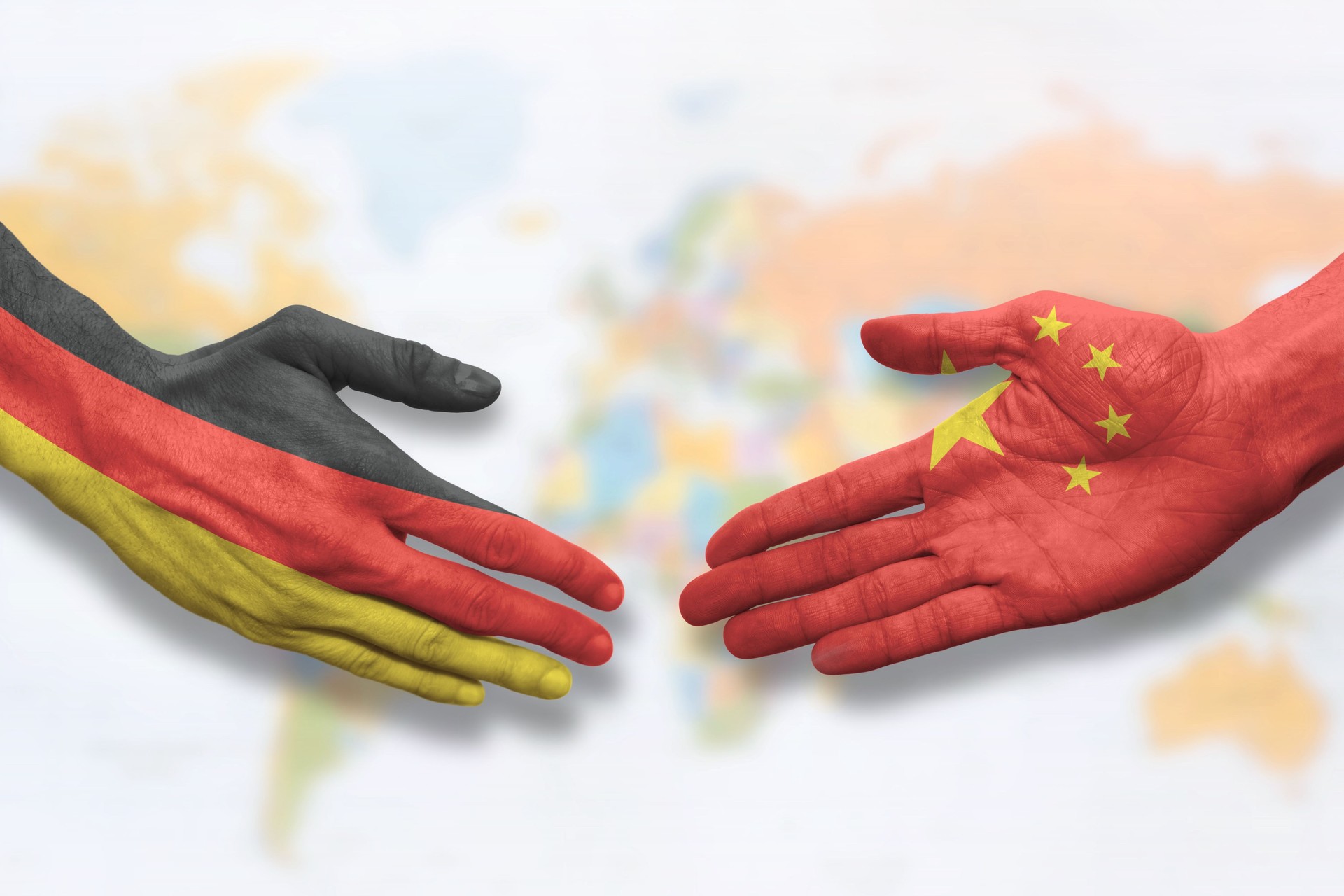 China and Germany - Flag handshake symbolizing partnership and cooperation